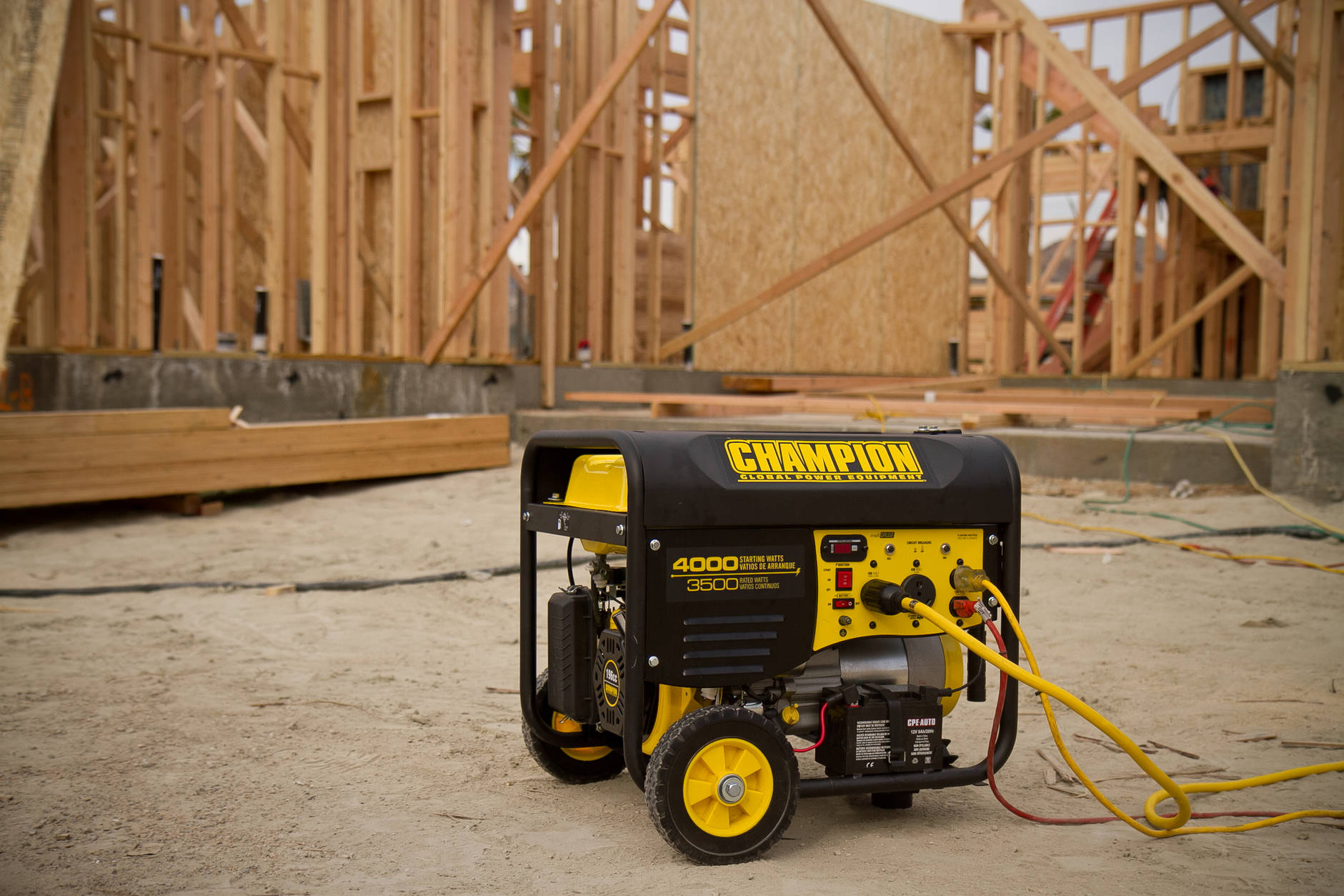 A Champion Power Equipment portable generator in use at a construction site.